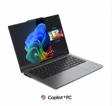 Front view of a Lenovo Legion series gaming laptop with the screen open and an RGB-backlit keyboard on a gray background